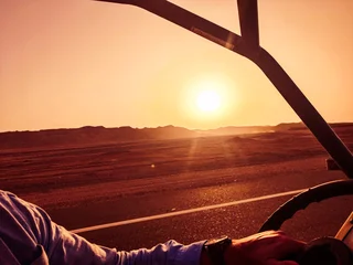 Fototapeten Bordeaux From the buggy, the view falls on the setting sun over the sandy desert – adventure meets stillness.  © The.Focus.Rebel