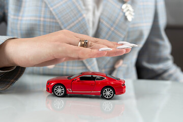 Insurance agent  holding red car toy as vechicle insurance
