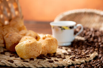 Cheese bread and coffee, delicious Brazilian cheese bread and a beautiful cup of coffee on a rustic...