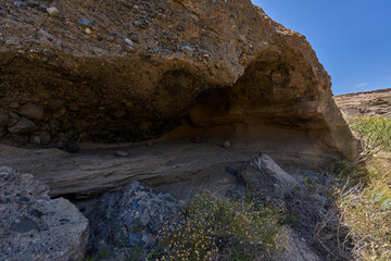 Volcanic cave with eroded layers