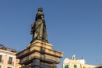 Naklejka premium Madrid, Spain. Monument to Queen Isabel II in Plaza de Isabel II, in front of the Royal Theatre. Sculpted by Jose Piquer Duart in 1850, it honors the monarch who inaugurated the opera house