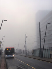 fog day in city with bus and buildings