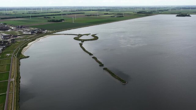 Aerial view of Tulpeiland in the Netherlands, a unique tulip-shaped island next to a coastal town