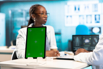 Fototapeta premium Health care professional engages in conversation with patient next to isolated display, combining medical expertise with support to ensure wellness. Physician discuss with young girl.