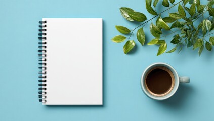 Blank notebook, coffee, and leaves on a desk