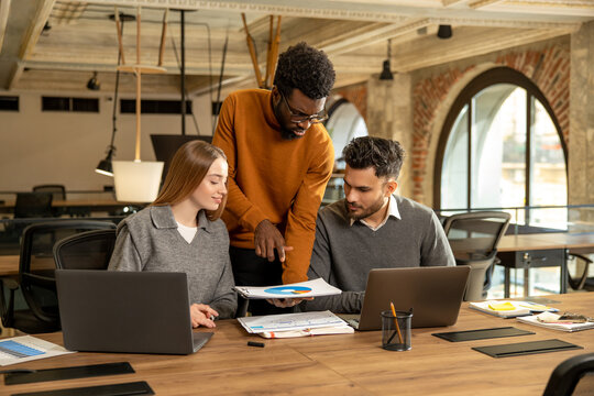 Coworkers discussing project details and looking interested