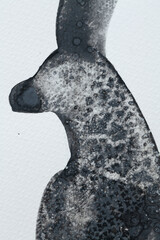 Unique black ink artwork featuring a silhouette of an animal against a textured background