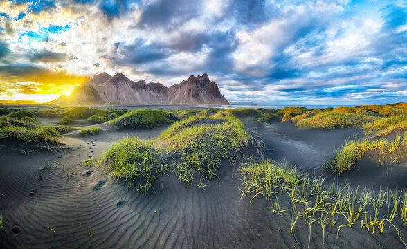 Impressive sunset with gorgeous black sand dunes on Stokksnes cape in Iceland.