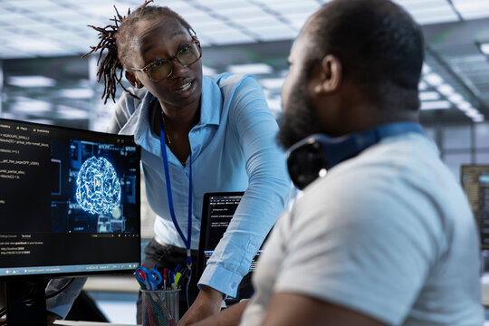 Manager admonishing AI programmer after making error damaging high tech data center. Supervisor scolding artificial intelligence expert after doing mistake in server room