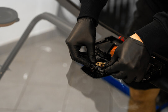 Sensor Installation on New Windshield After Replacement. Mounting sensor to ensure safety systems like lane assist and auto-braking work properly after replacing the windshield.