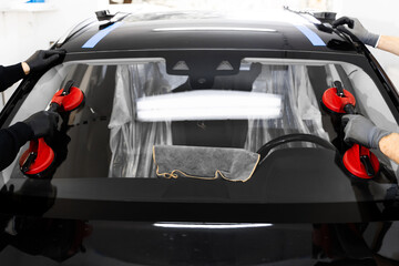 New Windshield installation process. Windshield Installation Using Suction Lifters. Two technicians...