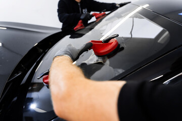New Windshield installation process. Windshield Installation Using Suction Lifters. Two technicians...