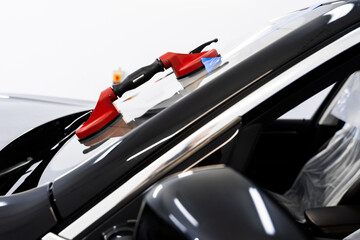 Windshield replacement using lifting tools that grip glass securely. Windshield technicians rely on...