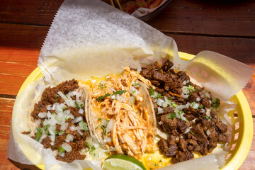 Chicken and beef taco plate served with lime wedges and diced onion at a casual taqueria in Burlingame, CA, on May 8, 2021