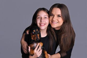 mãe e filha com cachorro fofo raça duchshund 
