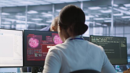 Woman seeing critical error on PC screen in data center, requesting help from cybersecurity team. Employee seeing security incidents affecting server room network system, camera A