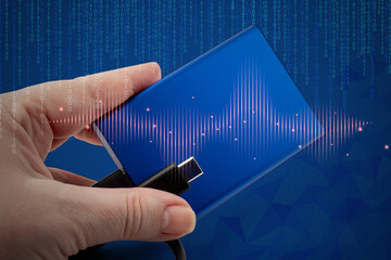 Hand holds external SSD with USB cable, surrounded by binary code and abstract waveforms. Concept of digital data transfer and secure storage. Digital connection and fast mobile backup