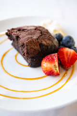 Flourless Chocolate Cake Served with Blue Berries and Strawberries