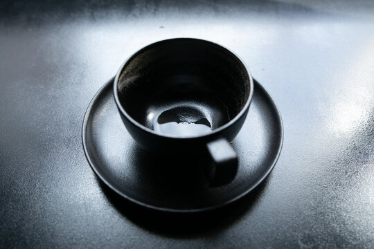 black cup on a black windowsill
