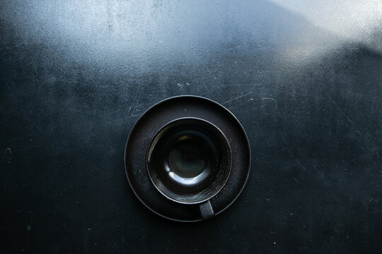 black cup on black windowsill, top view