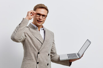 young caucasian man working with laptop wear beige blazer glasses hold computer device show gesture...