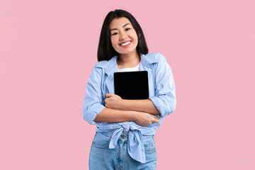Technology Lover Concept. Happy asian woman hugging tablet with black blank empty screen, holding...