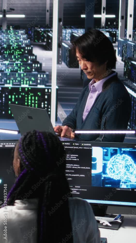Poster vertical video software developers cooperating in data center, reviewing ai diagnostics on computer.