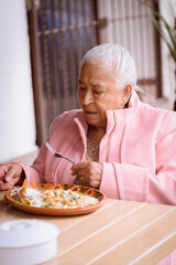 Old woman eating chilaquiles