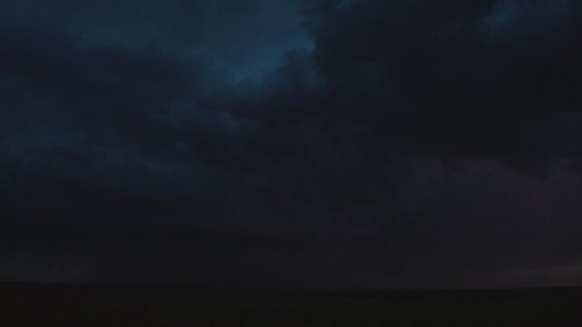 Massive Lightning Bolts Illuminate the Horizon on Stormy Night
