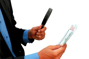close up photo of businessman's hand holding dollar bill and magnifying glass