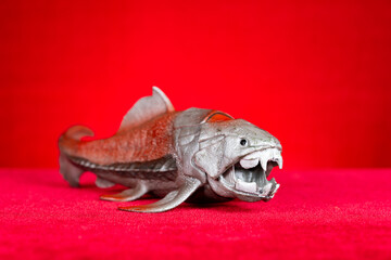 Dunkleosteus terrelli model on a red background