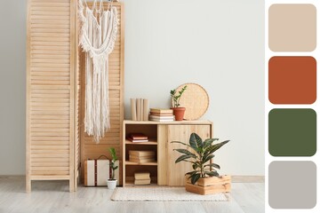 Folding screen, commode and books in interior of room. Different color patterns