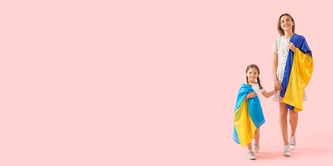 Going little girl and her mother with Ukrainian flags on pink background with space for text