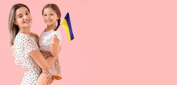 Cute little girl and her mother with Ukrainian flag on pink background - Powered by Adobe