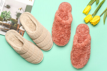 Two pairs of soft slippers and tulips on turquoise background. Top view