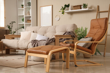 Interior of stylish living room with sofa, armchair and shelf unit