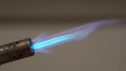 Metal Blowtorch Igniting Blue Flame on Grey Background for Industrial Applications - Powered by Adobe