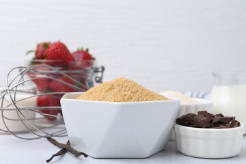 Different ingredients for panna cotta. Milk, sugar, vanilla, chocolate and strawberries on white table, closeup