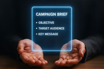 A hand holding a campaign brief for marketing