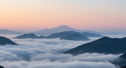 Serene Mountain Peaks Above Sea of Clouds at Sunrise