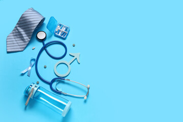 Male sign with ribbon, tie, stethoscope and medicine on blue background. Prostate cancer awareness...