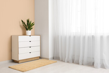 Interior of room with commode and light curtain