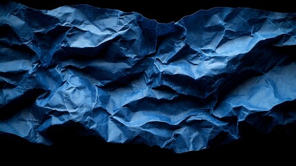 Fototapeta premium Close-up view of crumpled, deep blue paper.