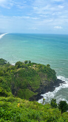 Bird eye view seashore with big wave crashing on rock cliff. Beautiful waves sea surface in sunny day