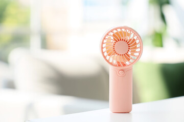 Small electric fan on table