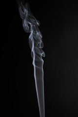Abstract figure created by white smoke on an isolated black background to stimulate the subconscious with truly beautiful shapes