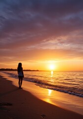 Fototapeta premium Woman Silhouetted Against a Vibrant Sunset on a Sandy Beach