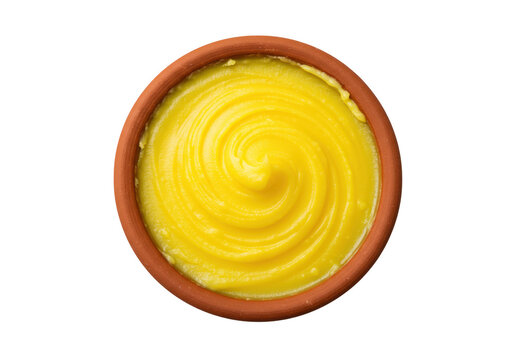 Golden ghee swirl in terracotta bowl isolated on transparent background