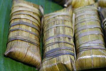 Fototapeta premium Bacang Zongzi Dumpling Wrapped in Bamboo Leaf – Festive Asian Snack