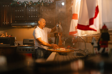 Latino man making traditional coffee in festive kitchen with steam